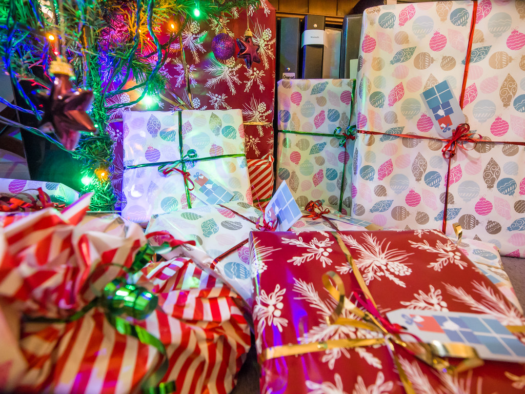 several wrapped presents under a christmas tree
