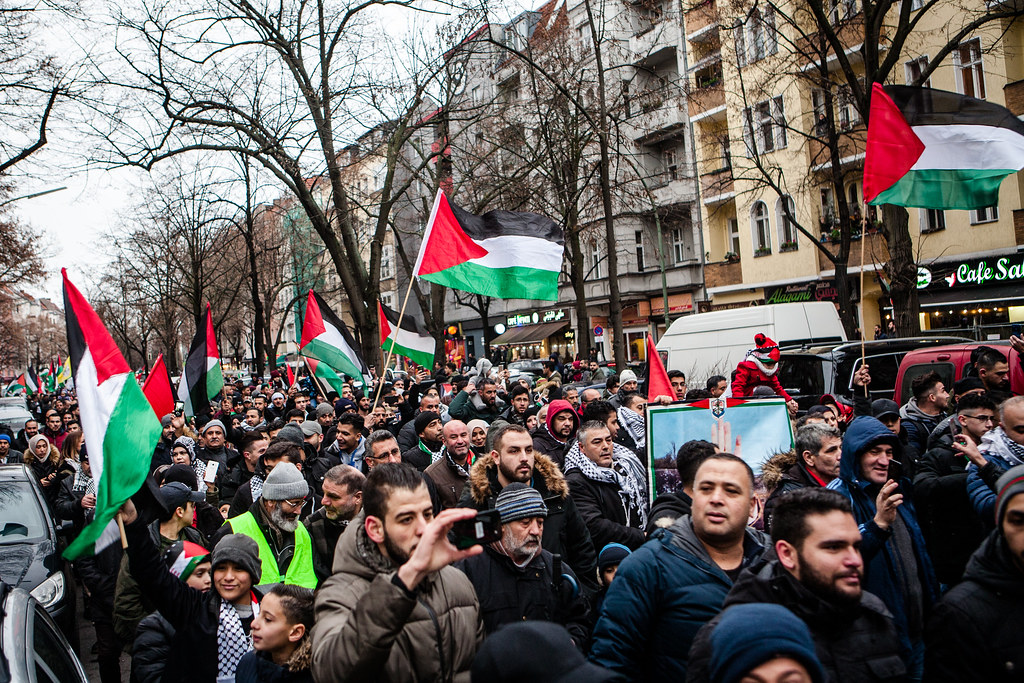 Protestors at a Palestinian solidarity march wave the Palestinian flag