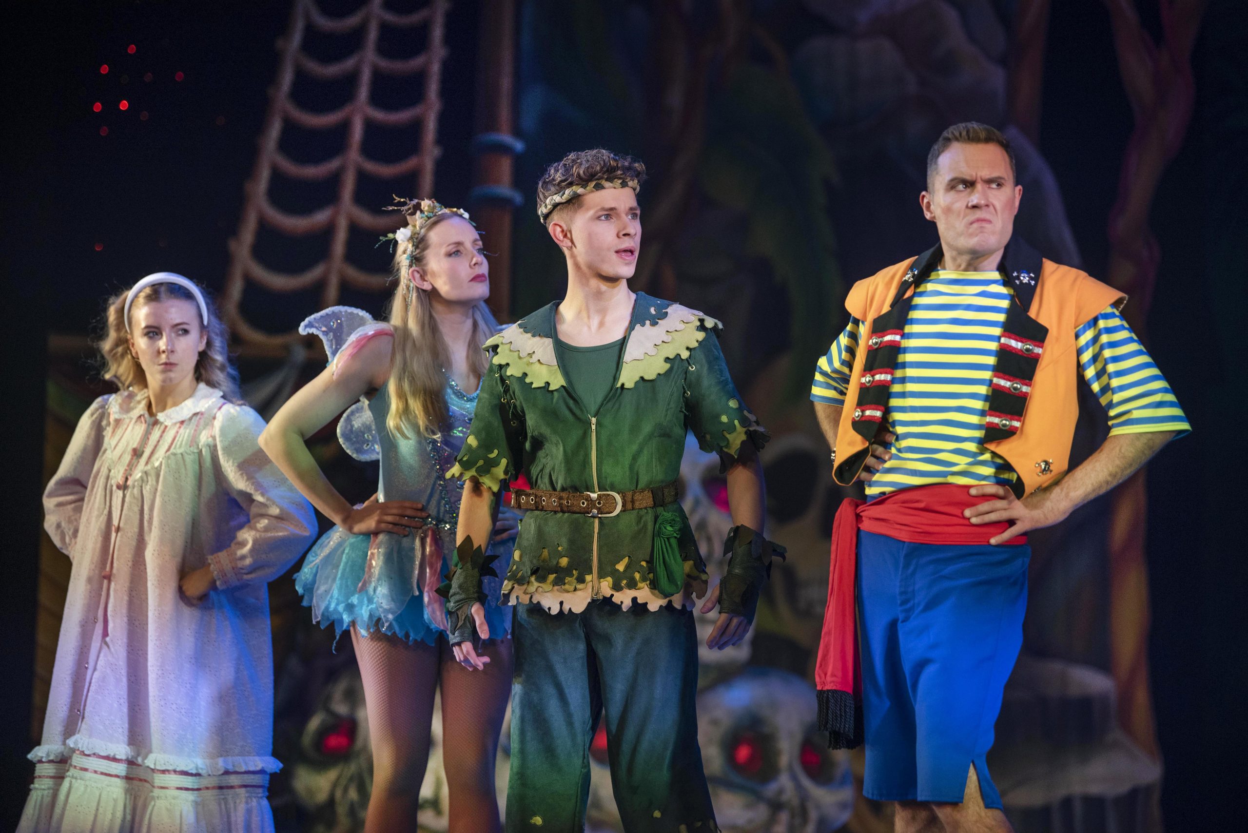 four characters on stage acting in a pantomime