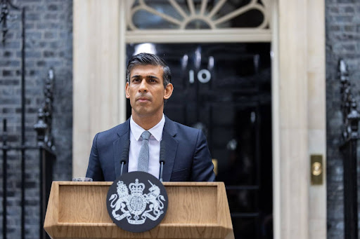 Rishi Sunak speaking behind a podium on No. 10 Downing Street.