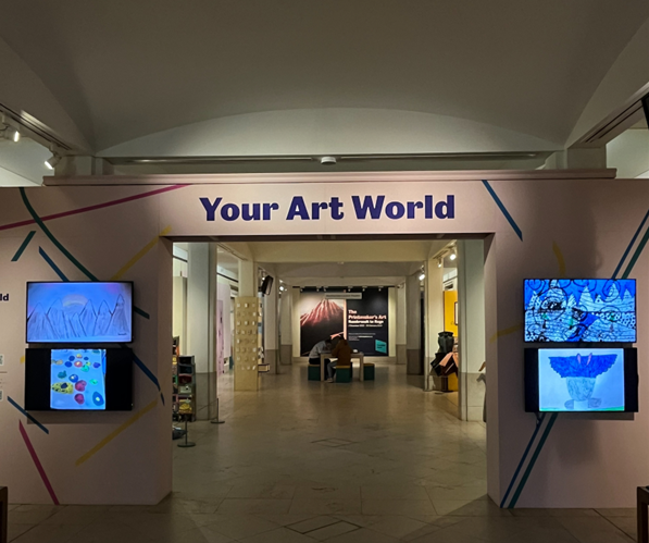 A large room with an doorway with the words "your art world". There are also four screens surrounding the doorway with artwork showing on them.